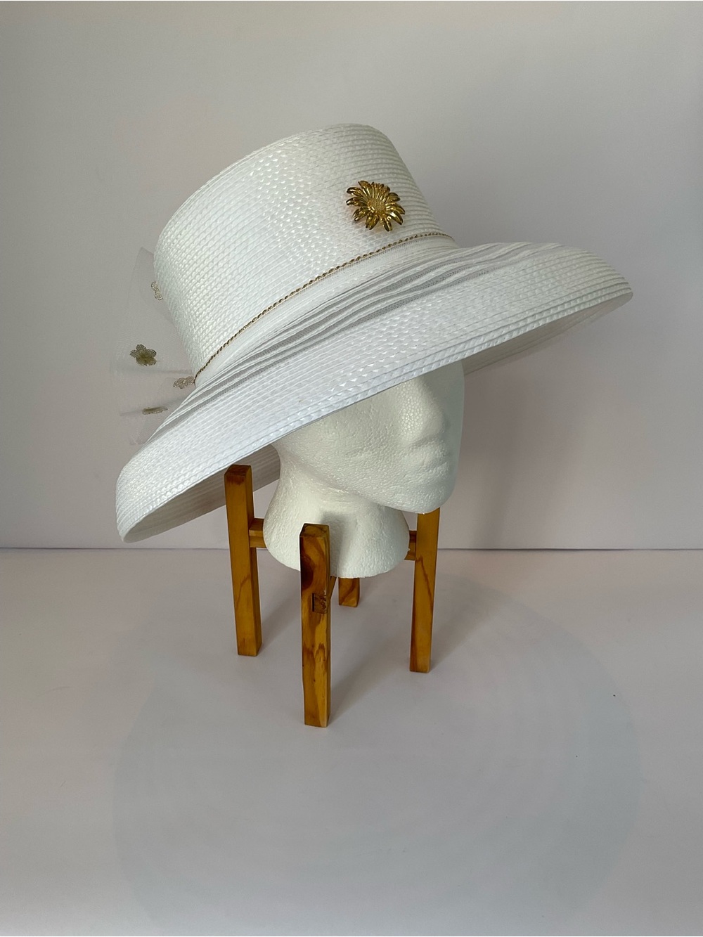 Elegant White Wide-Brim Church Hat with Net Lace Bow and Gold Floral Accent